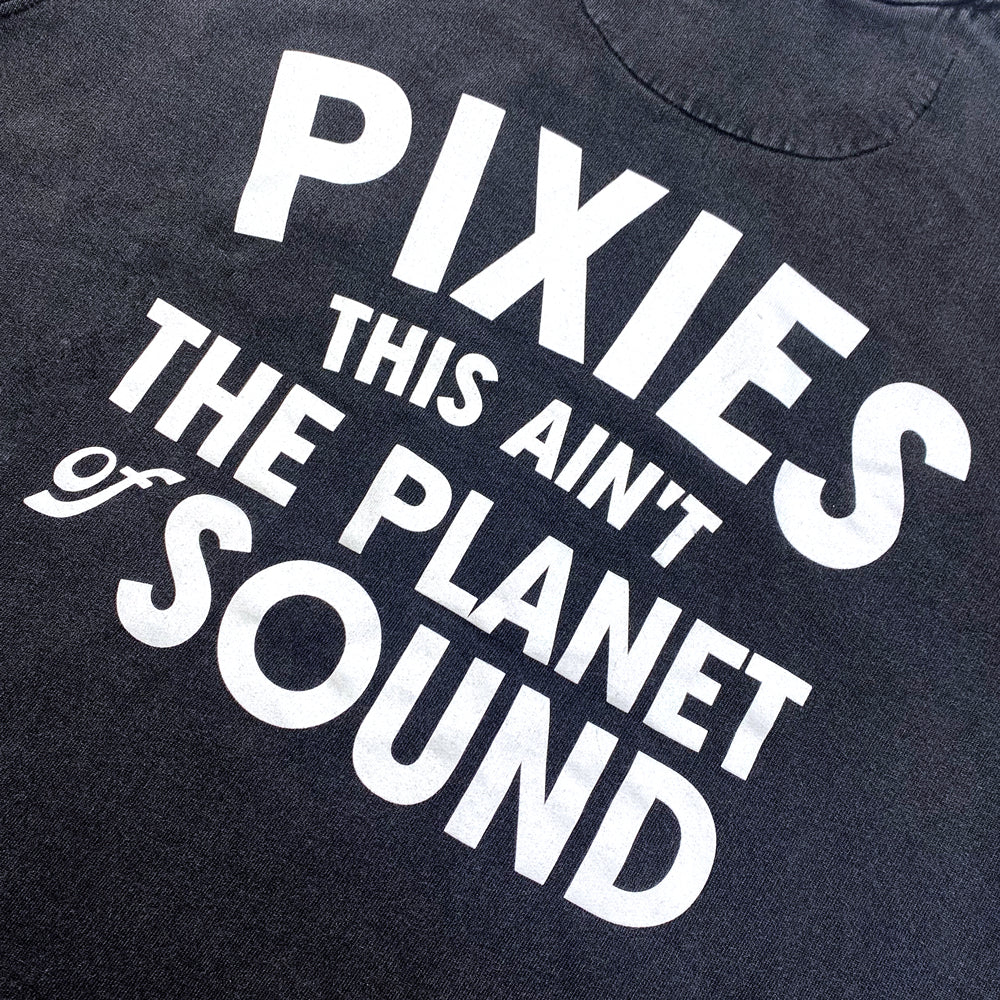 Close up of the back of a black Crewneck Sweatshirt with white text reading "Pixies This Ain't the Planet of Sound"